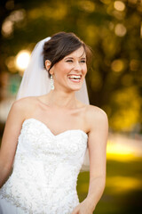 Beautiful, Happy Bride Holding Laughing Outside - Candid Portrait