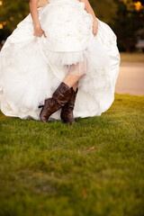 Bride in Wedding Dress and Brown Cowboys Boots Standing Outside