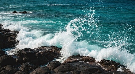 Dramatic Ocean Wave Crashing on Rocky Shore, Spraying Water, Turquoise Waters.