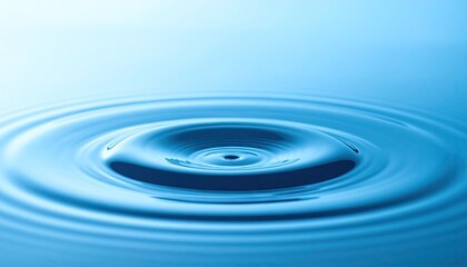 Blue Water Droplet Impacting Surface Creating Concentric Ripples