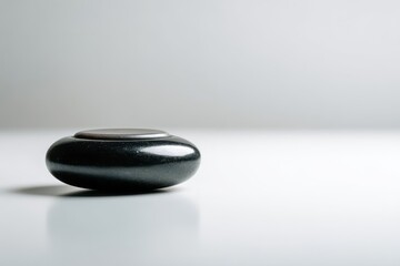 Smooth Black Stone on Minimalist Background for Relaxation and Meditation