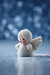 breathtaking snowy angel created from fresh soft snow lies on smooth ice surface illuminated by glimmering lights