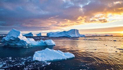 Aerial View of Icebergs in Open Water During Sunset with Dramatic Sky and Warm Tones Landscape Scene