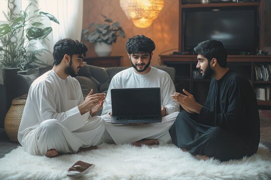 Three men sitting cross-legged on a white furry rug in a cozy living room sharing and discussing content on a laptop, engaged in an animated conversation with warm ambient lighting