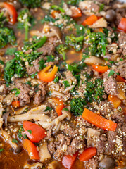 Close up of Healthy One Pot Meal of Ground Bison, Mushrooms, Broccoli, Barley, and Quinoa with Fresh Herbs