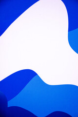 Minimalist abstract background featuring flowing blue and white wavy shapes. Ideal for graphic design, websites, and presentations.
