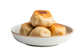 Delicious golden dumplings piled in a white bowl, perfect for savory meals.