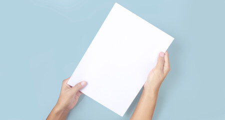 Hands holding paper blank for letter paper