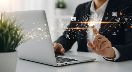 Business professional using digital technology with futuristic holographic interface on laptop in modern office environment for innovative work solutions