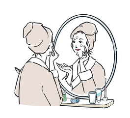 鏡の前に立つバスローブ姿の女性　スキンケア