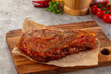 Raw marinated pork loin steak