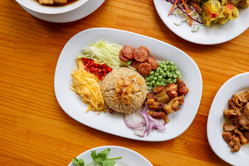 Delectable Cuisine Composition: A diverse assortment of dishes artfully arranged on a wooden table, enticing the senses with a vibrant symphony of textures and flavors.