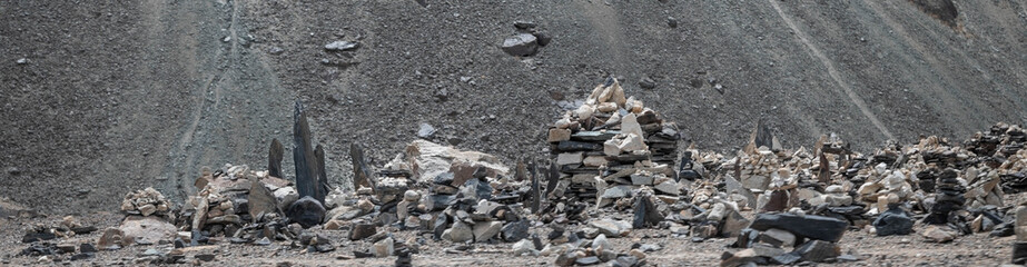 Stone cairn stacked on the roadside, symbolizing balance, spirituality, meditation, and inner peace in a natural outdoor setting