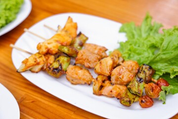 Grilled Chicken Skewers on Plate: A tantalizing overhead shot of grilled chicken skewers arranged artfully on a pristine plate.