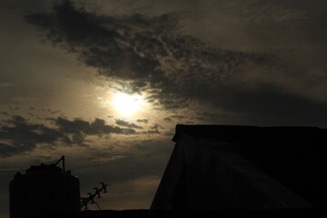 Golden sunset sky, yellow sun at dawn, orange clouds in the night sky above the view of summer...