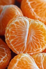 Close-up view of fresh peeled orange segments showing bright orange color and detailed texture
