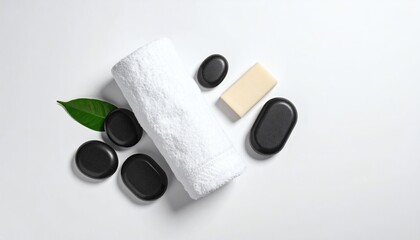 Elegant Wellness Flat Lay: Black Massage Stones and Spa Essentials on a Pure White Background