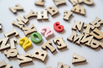 Colorful Wooden Letters with New Year 2026 Theme on White Background