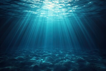 Obraz premium Sunlight penetrating clear blue ocean water illuminating the sandy seabed below with serene and tranquil underwater atmosphere