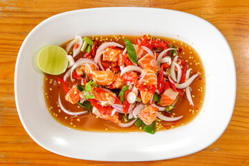 Appetizing Salmon Salad: a captivating overhead shot of a vibrant salmon salad, adorned with fresh vegetables and enticing spices, presented on a pristine plate. Perfect for culinary projects.