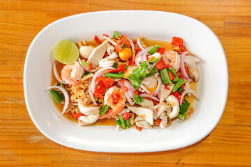Exotic Seafood Delight: An overhead shot of a plate showcasing a vibrant seafood dish, a colorful medley of flavors, textures, and aromas, ready to entice the senses.