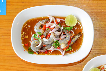 Appetizing Shrimp Dish: A culinary close-up showcases a flavorful shrimp dish, garnished with fresh ingredients and presented on a crisp white plate. A celebration of culinary art.