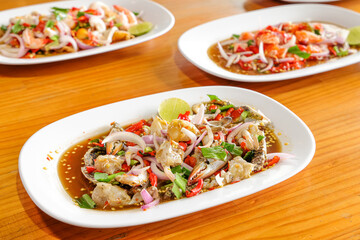 Seafood Salad Platter: A vibrant array of seafood salads, each plate showcasing a refreshing blend of ingredients and flavors, presented on a wooden table, inviting a delightful culinary experience.