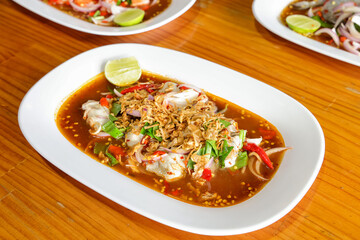 Appetizing Thai Dish: A vibrant overhead shot captures a delightful Thai dish, artfully arranged on a pristine white plate, showcasing the exquisite culinary artistry and enticing flavors.