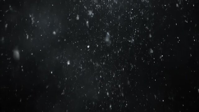 A seamlessly looping video showcasing abstract particles of white light gently raining down through a dark, hazy atmosphere energy, modern, raining