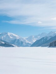 Snow-covered mountains and frozen lake under a clear blue sky
