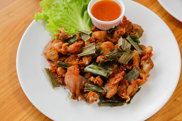Savoring Culinary Delight: A meticulously arranged plate displays a tantalizing dish, garnished with fresh greens and a vibrant dipping sauce.