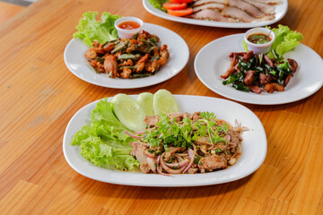 Culinary Platter: A vibrant and tempting arrangement of varied food dishes, artfully presented on plates, featuring fresh ingredients and vivid colors on a wooden table.