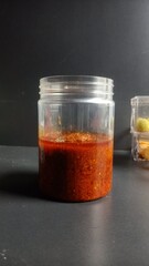 Spicy sambal bawang, an Indonesian chili paste made from fresh chili peppers and garlic, offering bold, intense flavors. Perfect as a side to add a fiery kick to your favorite dishes.