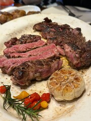 Juicy beef steak cooked to perfection with seared golden-brown crust, tender pink interior, and visible grill marks, showcasing its rich texture and mouthwatering detail in close-up view