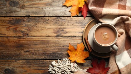 A warm autumnal beverage rests on a rustic wooden table, surrounded by colorful autumn leaves and a cozy plaid blanket, evoking a comforting autumnal ambiance.