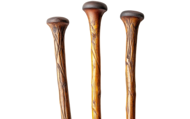 Three antique wooden walking canes with carved handles isolated on transparent background