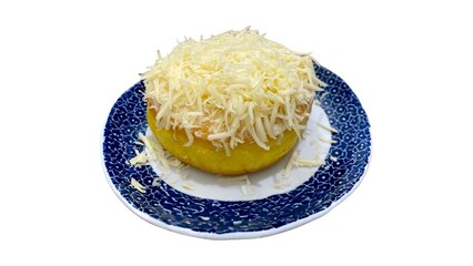 A potato donut topped with cheese on a blue patterned plate, set against a white background.