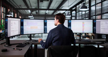 Senior Accountant Calculating Taxes On Electronic Spreadsheet