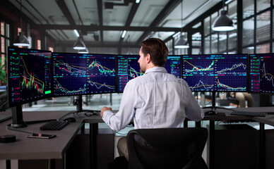 Senior Broker Analyzing Stock Market Data At Office Desk