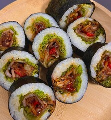 Delicious kimbap rolls filled with fresh vegetables, seasoned rice, and savory proteins, all wrapped in crisp seaweed. A perfect combination of flavor and texture in every bite.