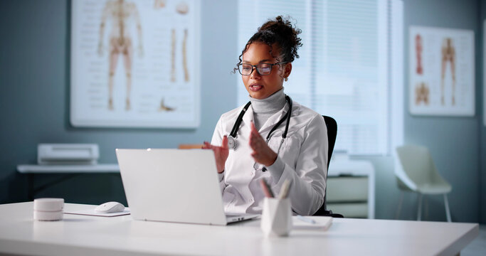 Happy African American Female Doctor Smiles During Online Telehealth