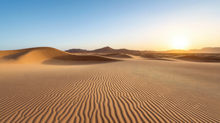 Golden desert dunes under clear sky at sunrise, creating serene and tranquil atmosphere