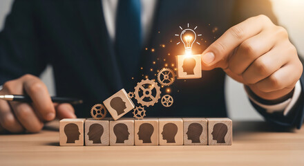 Hand places head cube with light bulb idea, symbolizing innovation and success