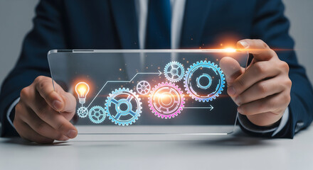 Business professional displays digital gears and glowing lightbulb for innovation