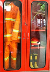 Firefighter uniform and gear stored neatly in a safety cabinet