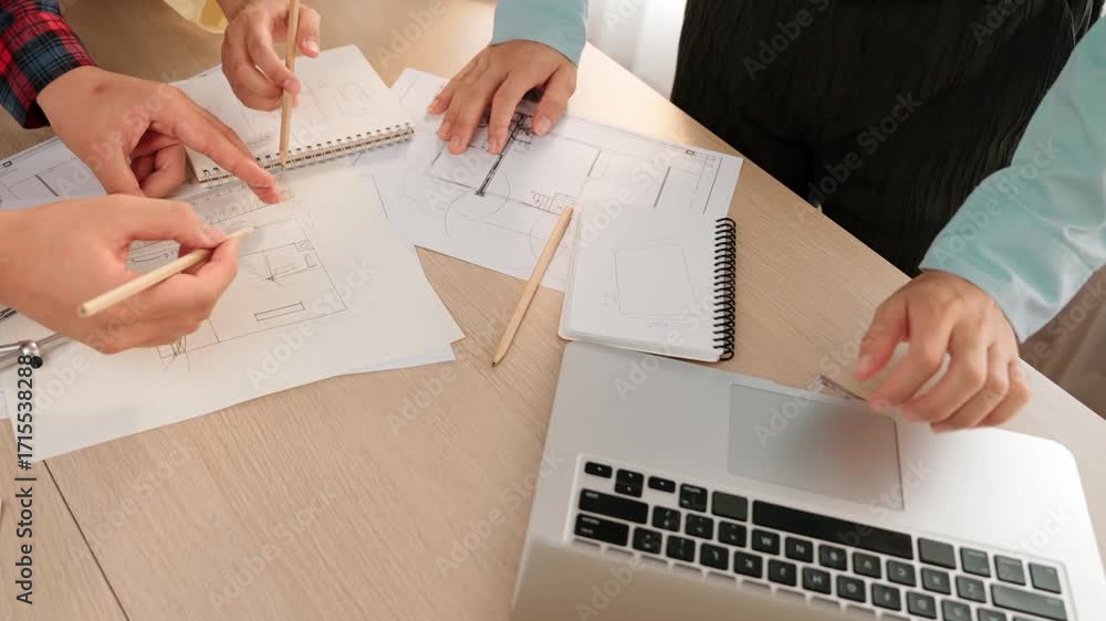 Poster architect and safety engineer discussion about building blueprint displaying on laptop on table usin