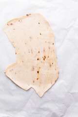 Overhead view of fire crackers dough on parchment paper, top view of spicy cracker dough, process of making fire crackers