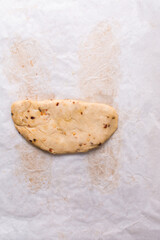 Overhead view of fire crackers dough on parchment paper, top view of spicy cracker dough, process of making fire crackers