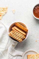 Overhead view of homemade crackers in a ramekin, top view of cracker biscuits on background