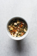 Overhead view of dehydrated mixed vegetables in a white ramekin, top view of mixed dried vegetables on a white countertop